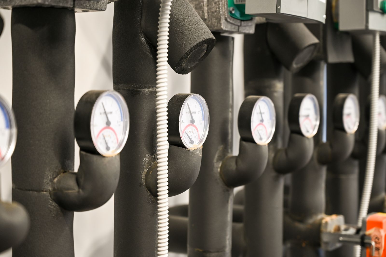Industrial pipe loop with several pressure gauges along the line.